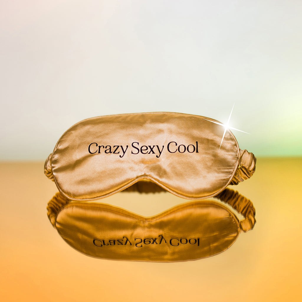 gold silk sleep face mask with black text 'crazy sexy cool'