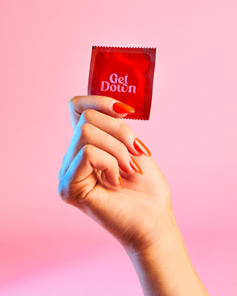 hand holding a get down condom