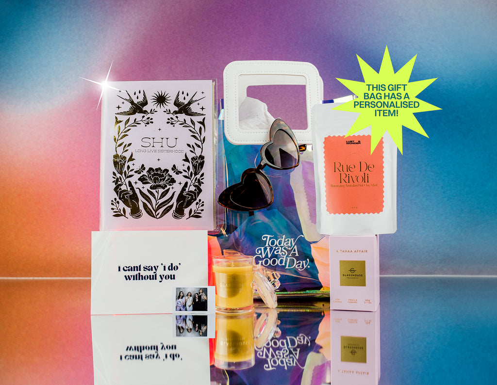 Gift bag sample containing heart shaped glasses, pink clay mask, glasshouse candle, gold foil custom print and polaroid photo of bridesmaids. Gift card says I can't say i do without you. 