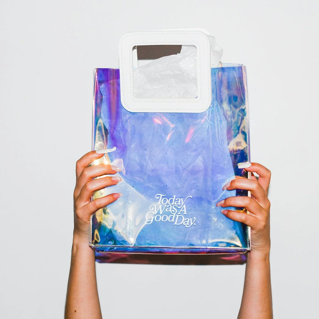 hands holding holographic gift back that says Today was a good day