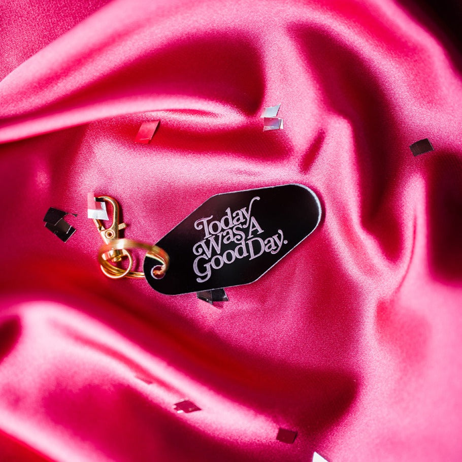 mirrored motel keyring, etched with today was a good day over pink silk